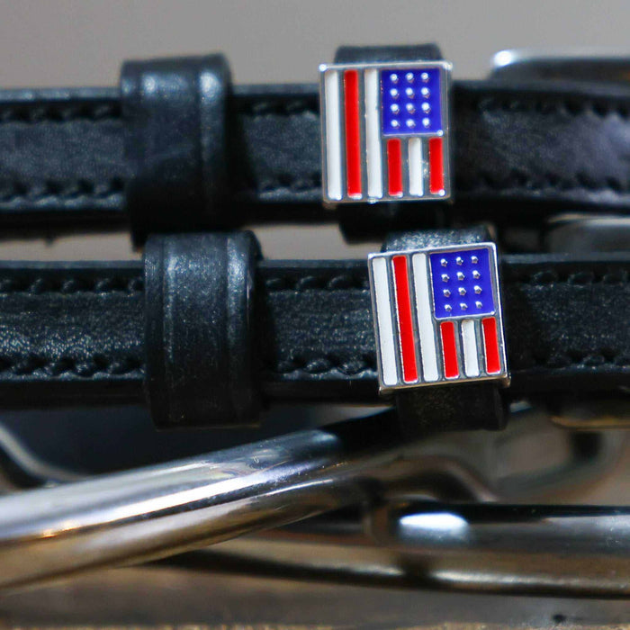 Close-up of enamel American flag charms on black leather spur strap keepers
