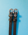 Black leather ManeJane spur straps with round Aquarius zodiac charms on light blue