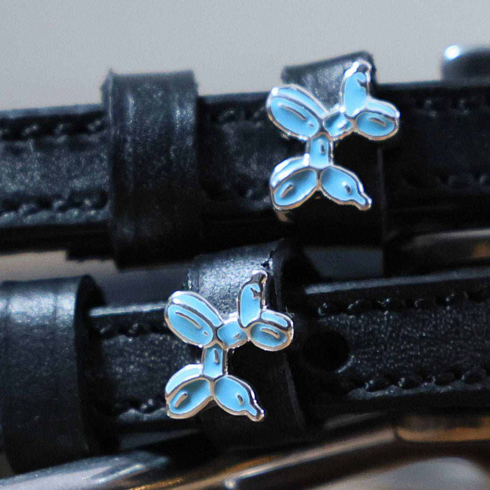 Close-up of blue balloon dog charms on black leather ManeJane spur straps