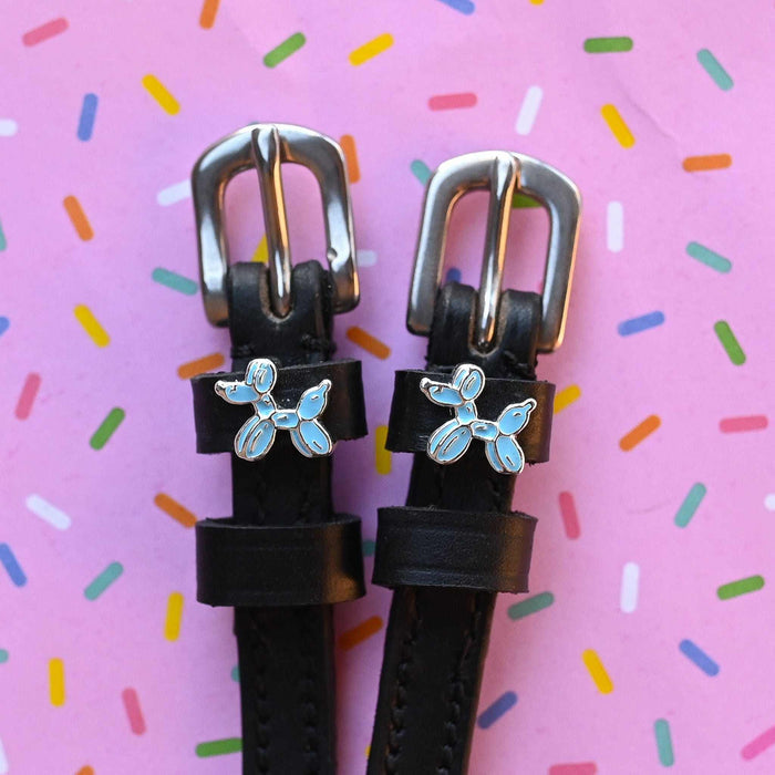 Balloon dog spur straps in black leather on a pink sprinkle confetti background
