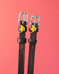 Black leather ManeJane Banana spur straps with silver buckles and banana charms on coral