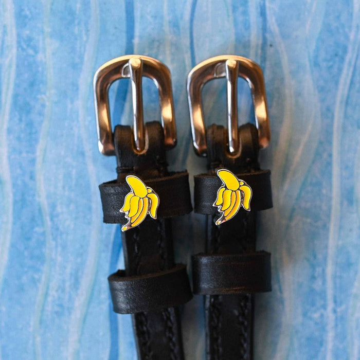 Banana spur straps with rose gold buckles and yellow banana charms on light blue