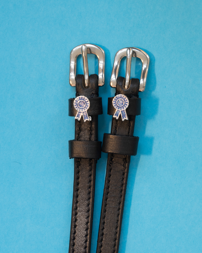 Black leather ManeJane spur straps with silver buckles and blue prize-ribbon rosette charms