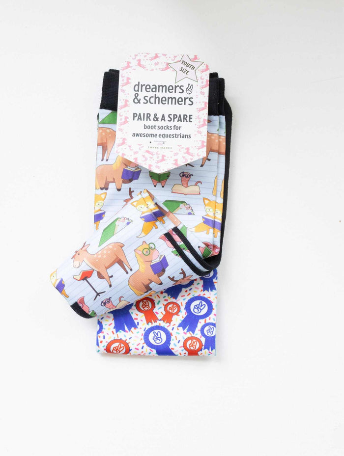 Bookworm youth boot socks shown folded with the included spare sock and patterned cuff