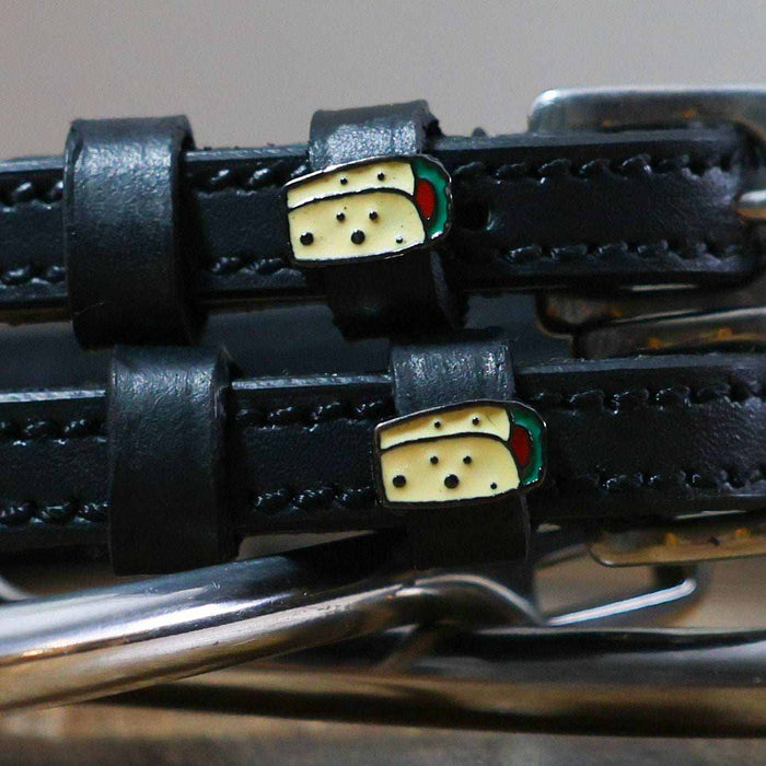 Close-up of enamel burrito charms on the keepers of black leather ManeJane spur straps