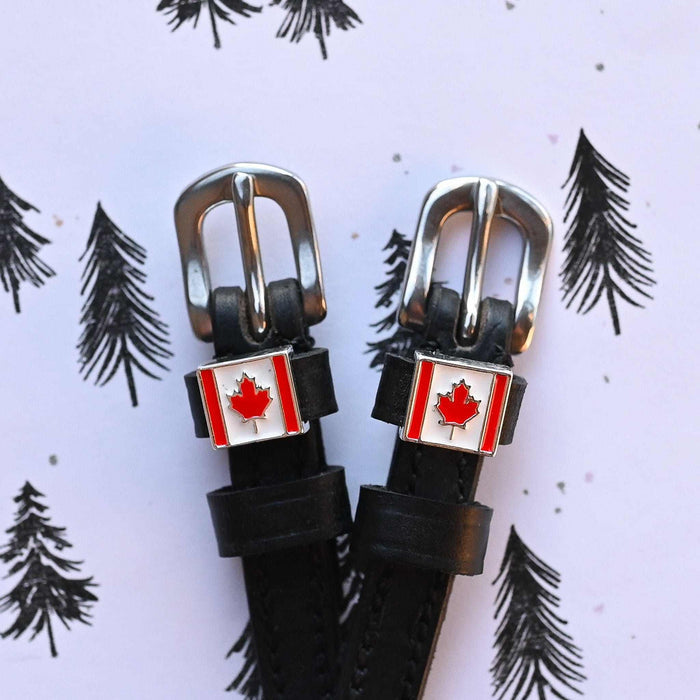 Canadian flag spur straps with silver buckles on a lilac pine-tree print background