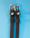 Pair of black leather ManeJane spur straps with winged cash charms on blue