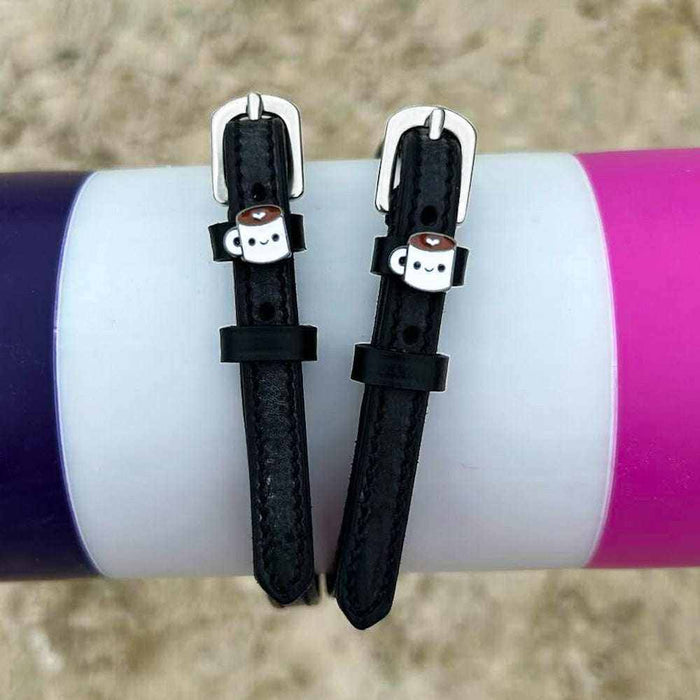 ManeJane coffee-mug spur straps wrapped around a white bottle outdoors