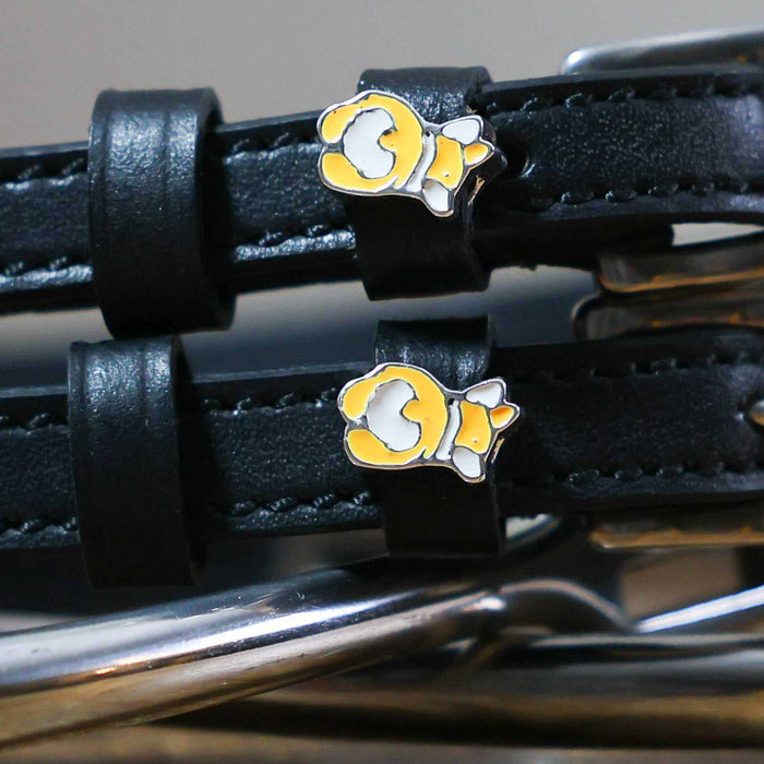 Close-up of a corgi butt charm on a black leather spur strap keeper