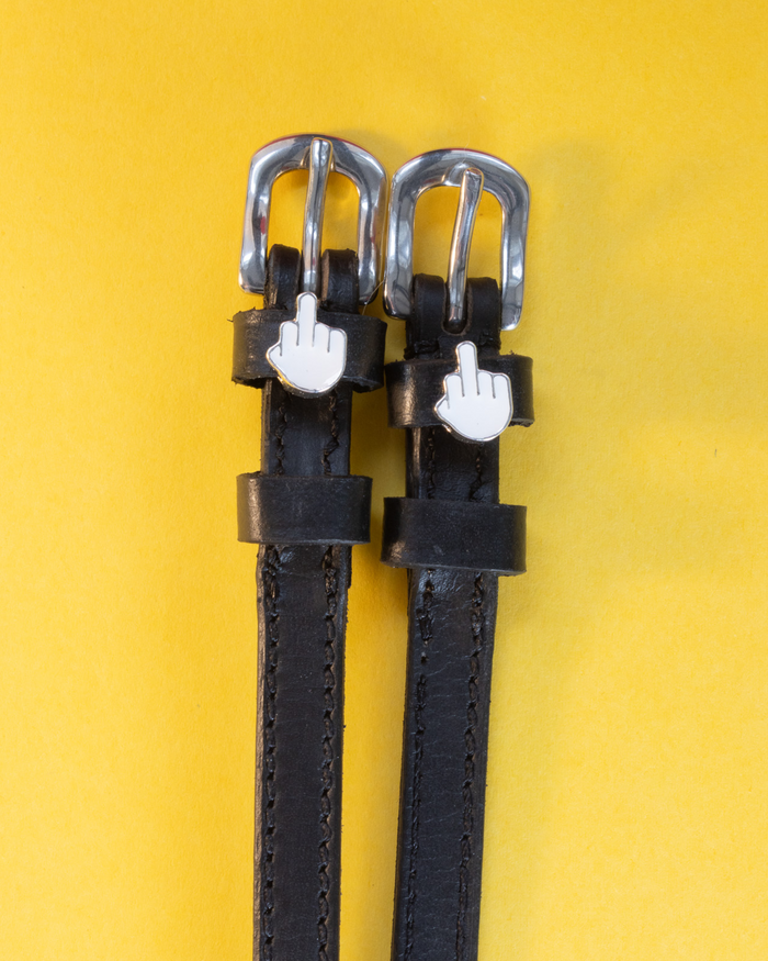 ManeJane Da Bird spur straps in black leather with white emoji charms on a bright yellow background