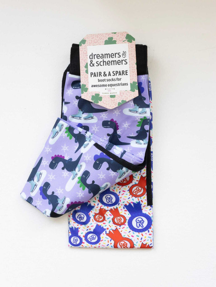 Dino-skate boot socks shown folded with the included spare sock and printed cuff detail