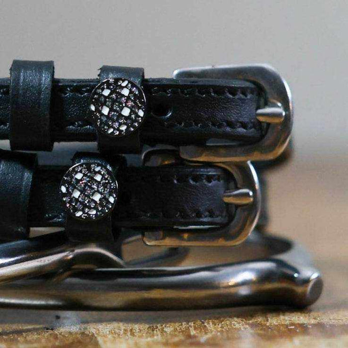 Close-up of crystal disco ball charms on black leather ManeJane spur strap keepers
