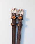 Brown leather ManeJane spur straps with silver buckles and golden Labrador dog face charms