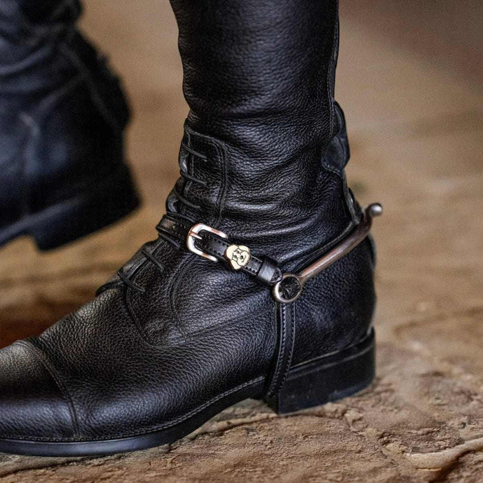 ManeJane poodle spur strap fastened on a rider's black English riding boot