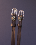 Dark brown ManeJane spur straps with double silver star charms on charcoal