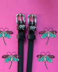 Dragonfly ManeJane spur straps with the signature Dragonfly charm, shown on a magenta background
