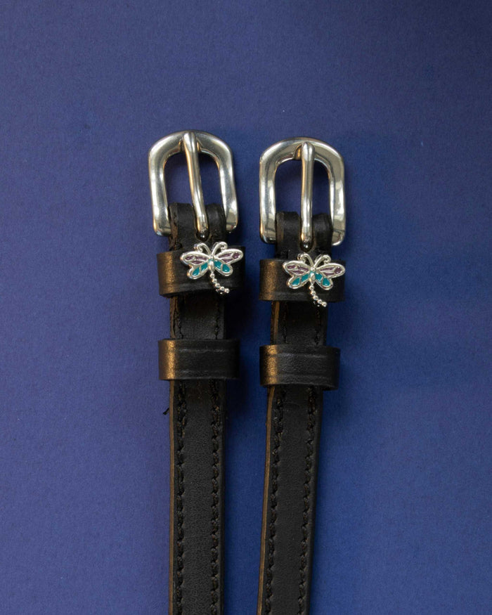 Dragonfly ManeJane spur straps with the signature Dragonfly charm, shown on a navy background