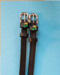 Black leather ManeJane spur straps with silver buckles and dumpster fire charms on blue