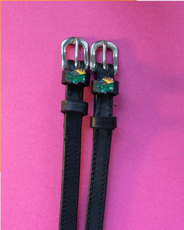Black leather dumpster fire charm spur straps with silver buckles on hot pink