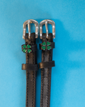 Black leather ManeJane four leaf clover spur straps with silver buckles and green clover charms