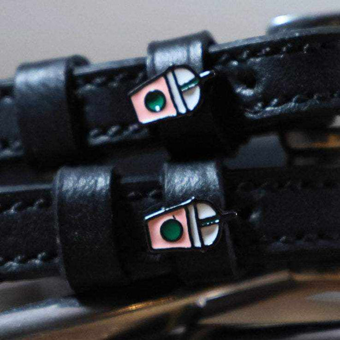 Close-up of iced coffee frappe cup charms on black leather spur strap keepers