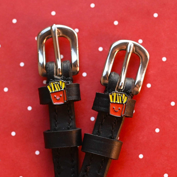 French Fries spur straps with rose gold buckles and fry charms on a red polka-dot backdrop
