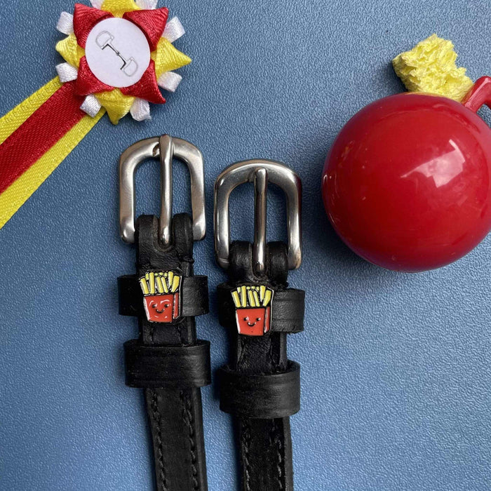 French Fries spur straps styled with a show rosette and red apple on a blue background