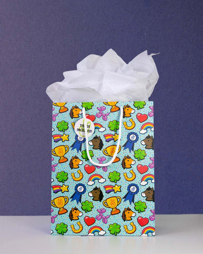 Full O' Luck medium gift bag front-on against navy, tissue paper puffed above the pale aqua print.