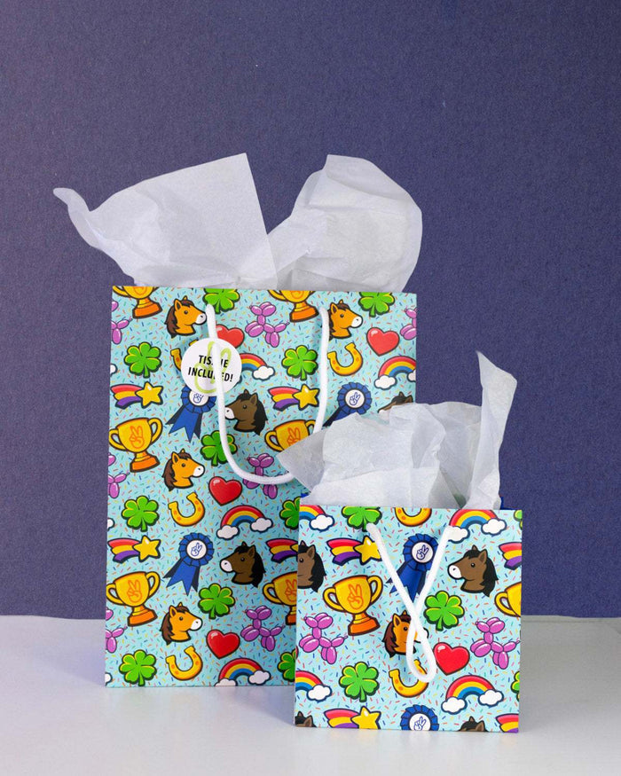 Full O' Luck gift bags in medium and small together on navy, both stuffed with white tissue paper.