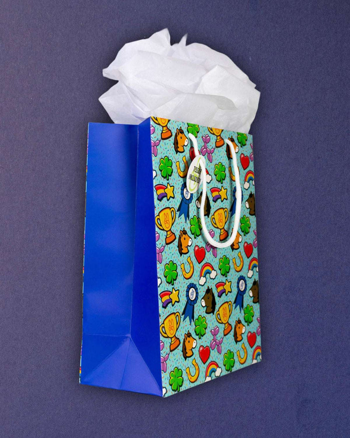Full O' Luck medium gift bag at three-quarters, Tissue Included tag clear against the aqua print.