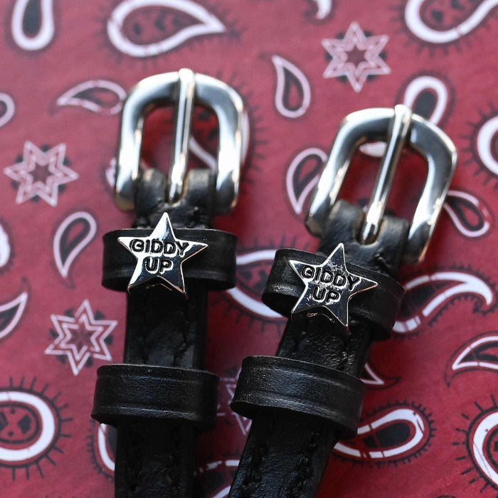 Black leather 'Giddy Up' star spur straps on a red paisley bandana background by ManeJane