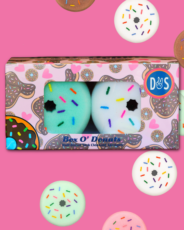 Box O' Donuts tack cleaning sponges, donut-shaped sponges with sprinkles in printed packaging by Dreamers & Schemers