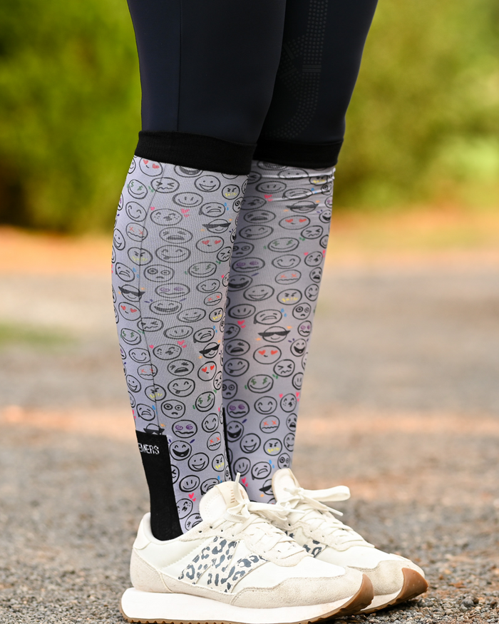 Horse Ownership riding boot socks styled over breeches, soft grey with the emoji faces of horse ownership