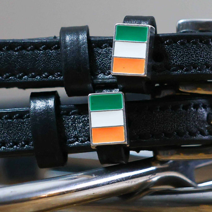 Close-up of Irish tricolor flag charms on black leather spur strap keepers
