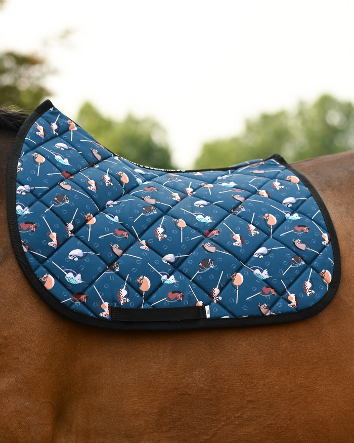 Dark teal It's Not a Hobby pad with pastel hobby horses and horseshoe outlines, no saddle, outdoors