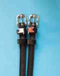 Black leather spur straps with silver buckles and white L and red R jump-flag charms on blue