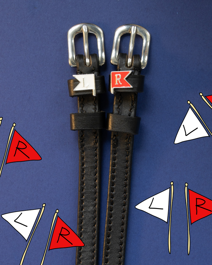 Jump-flag spur straps with L and R charms on a navy pennant-print background