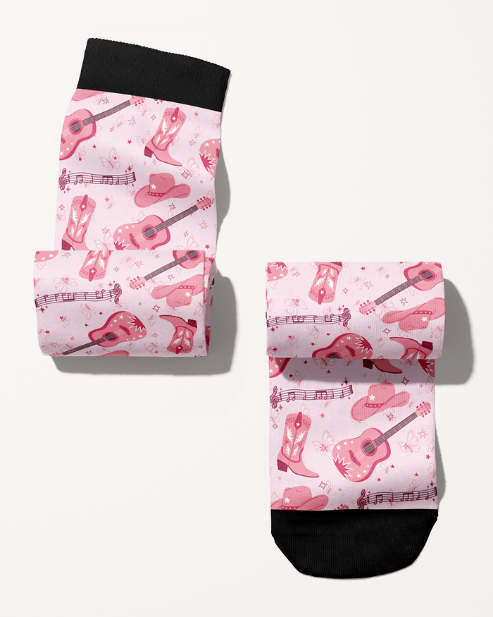 Dolly Forever boot socks rolled into a pair, pink cowgirl boots, guitars and hats print