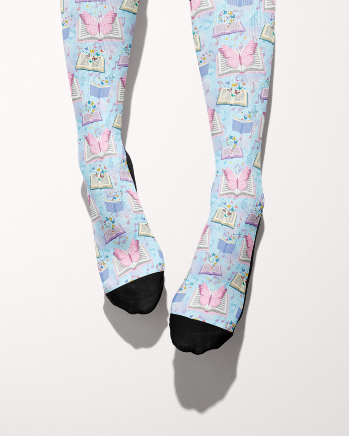 Reading 9-5 socks shown on bare feet, black toes against the books-and-butterflies print