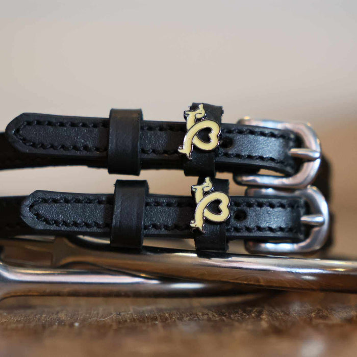 Close-up of gold dachshund heart charms on black leather Long Dogs spur straps, ManeJane