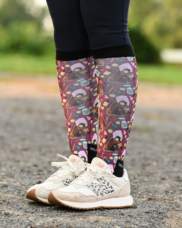 Mani Pedi riding boot socks styled over breeches, deep maroon with horses in spa turbans and cucumber slices