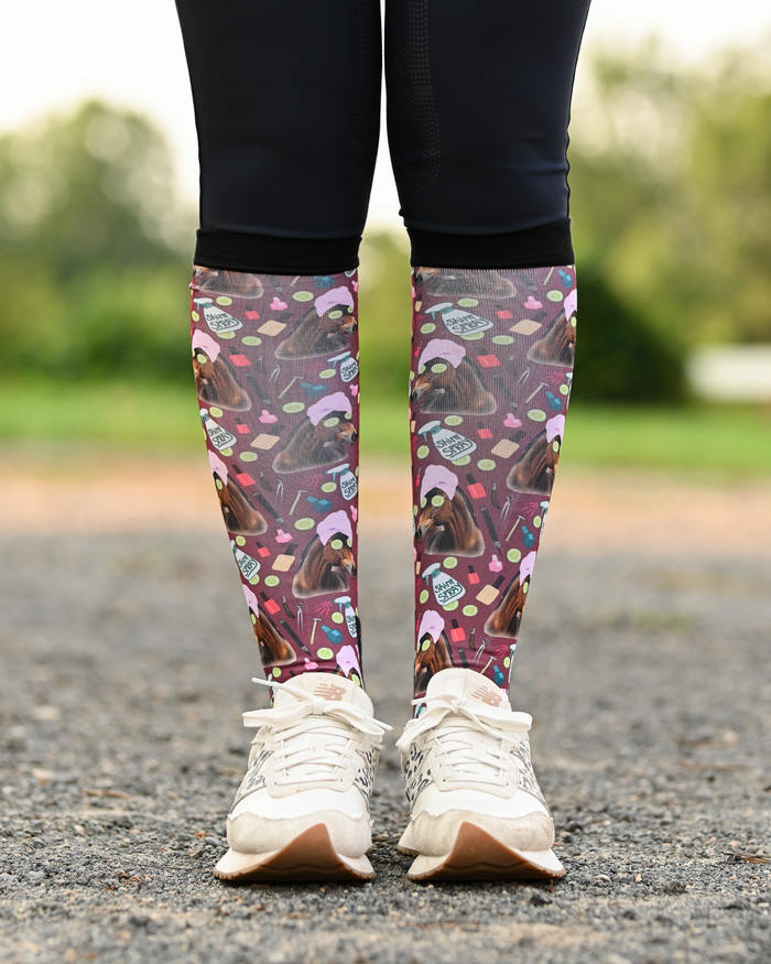 Mani Pedi equestrian boot socks worn at the barn, deep maroon with horses in spa turbans and cucumber slices