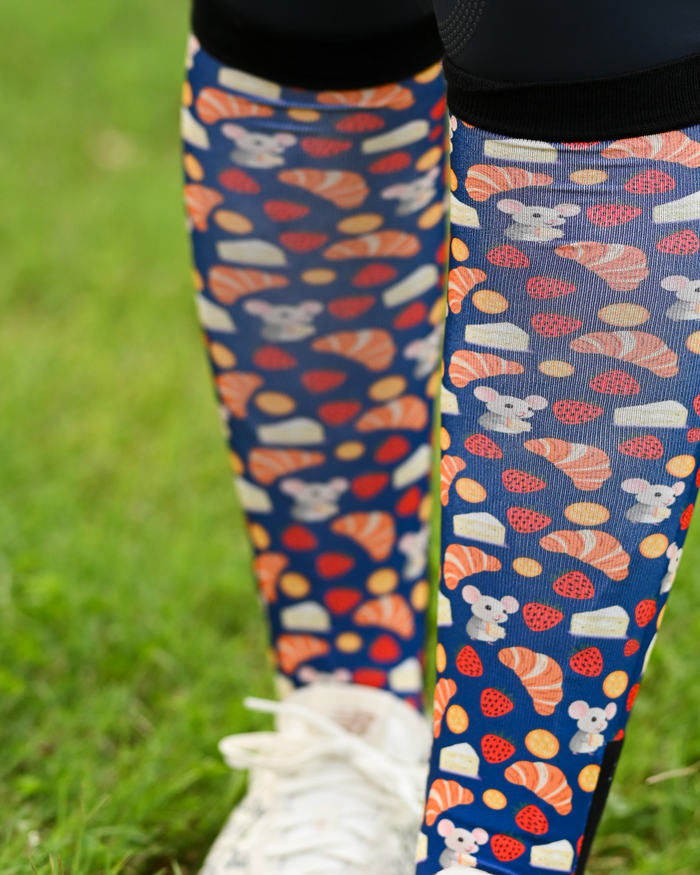 Close crop of the Merci boot sock print, croissants, macarons and strawberries on navy