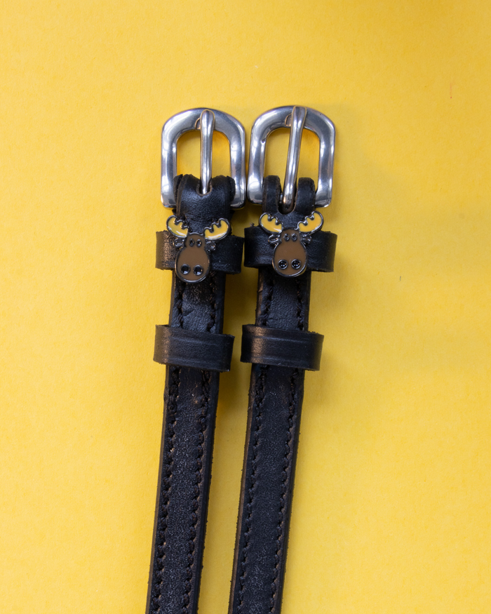 Black leather ManeJane spur straps with enamel moose head charms on yellow