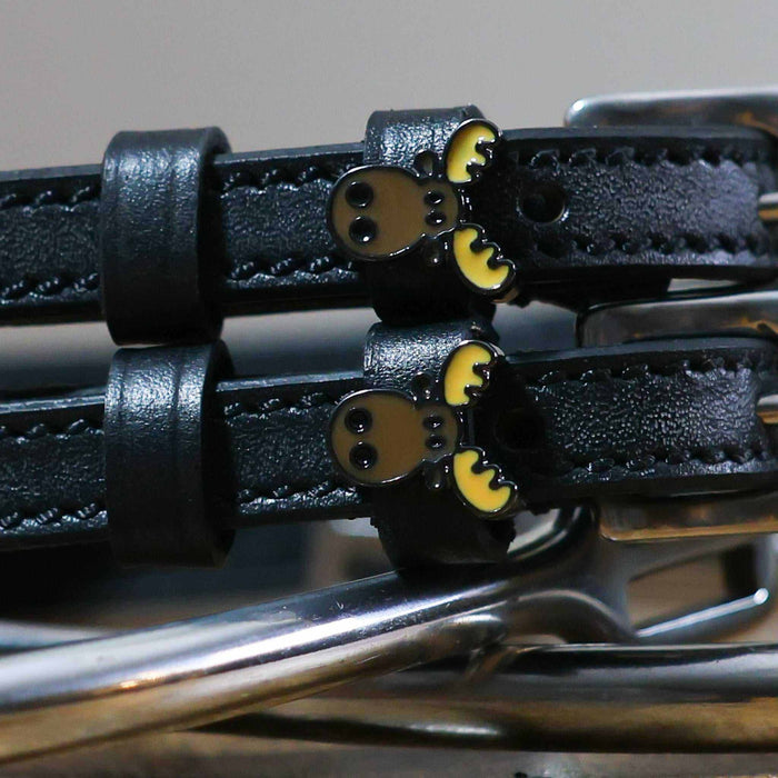 Close-up of brown moose head charms on black leather spur strap keepers