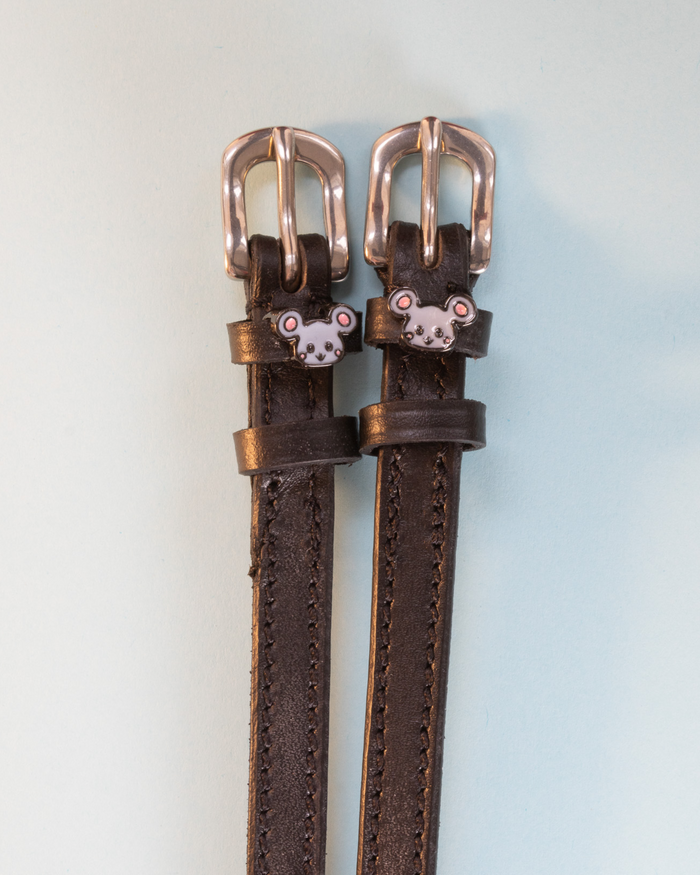 Dark brown Mouse spur straps with rose gold buckles and grey mouse charms on pale blue