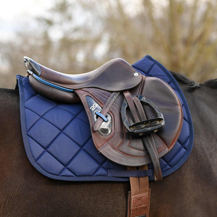 Blue equestrian bundle featuring navy saddle pad, brown leather saddle, and blue ribbon spur straps on horse