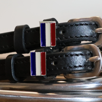 Close-up of red, white and blue Netherlands flag charms on black leather spur straps