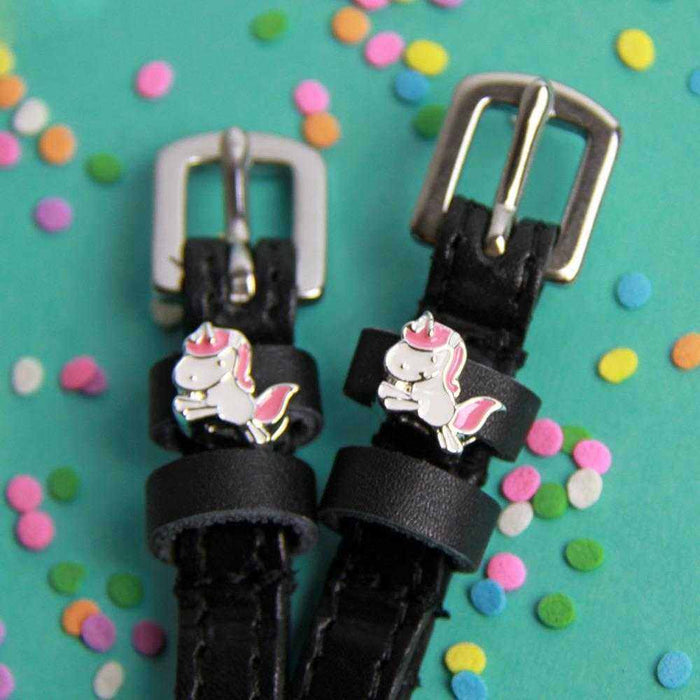 Unicorn charm spur straps with silver buckles on teal with confetti sprinkles