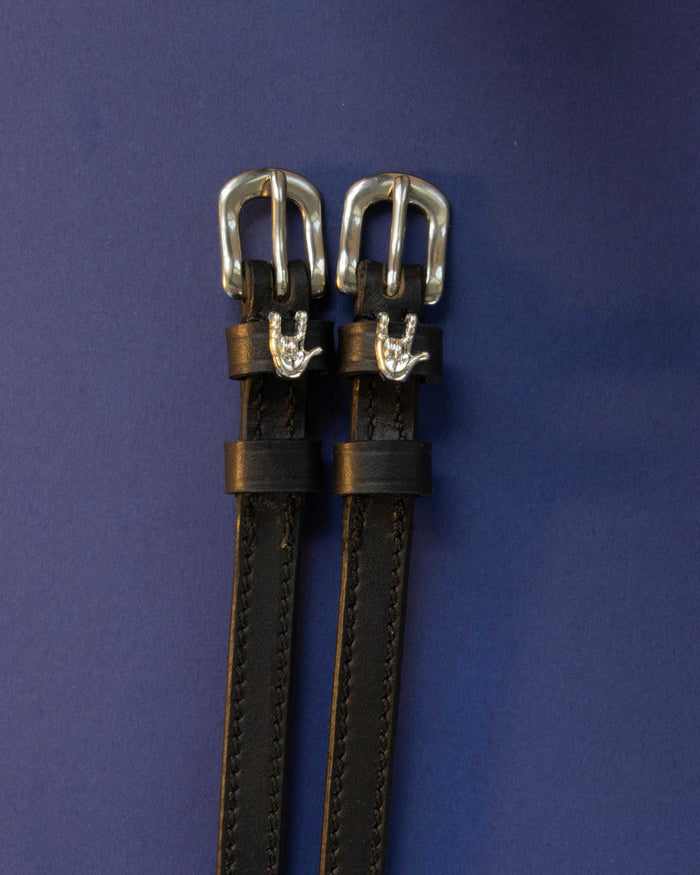 Rock On ManeJane spur straps with the signature Rock On charm, shown on a navy background